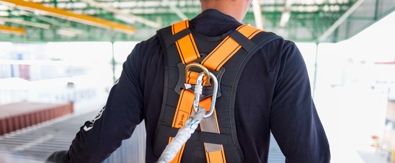 Construction Worker wearing safety harness Construction Worker wearing safety harness